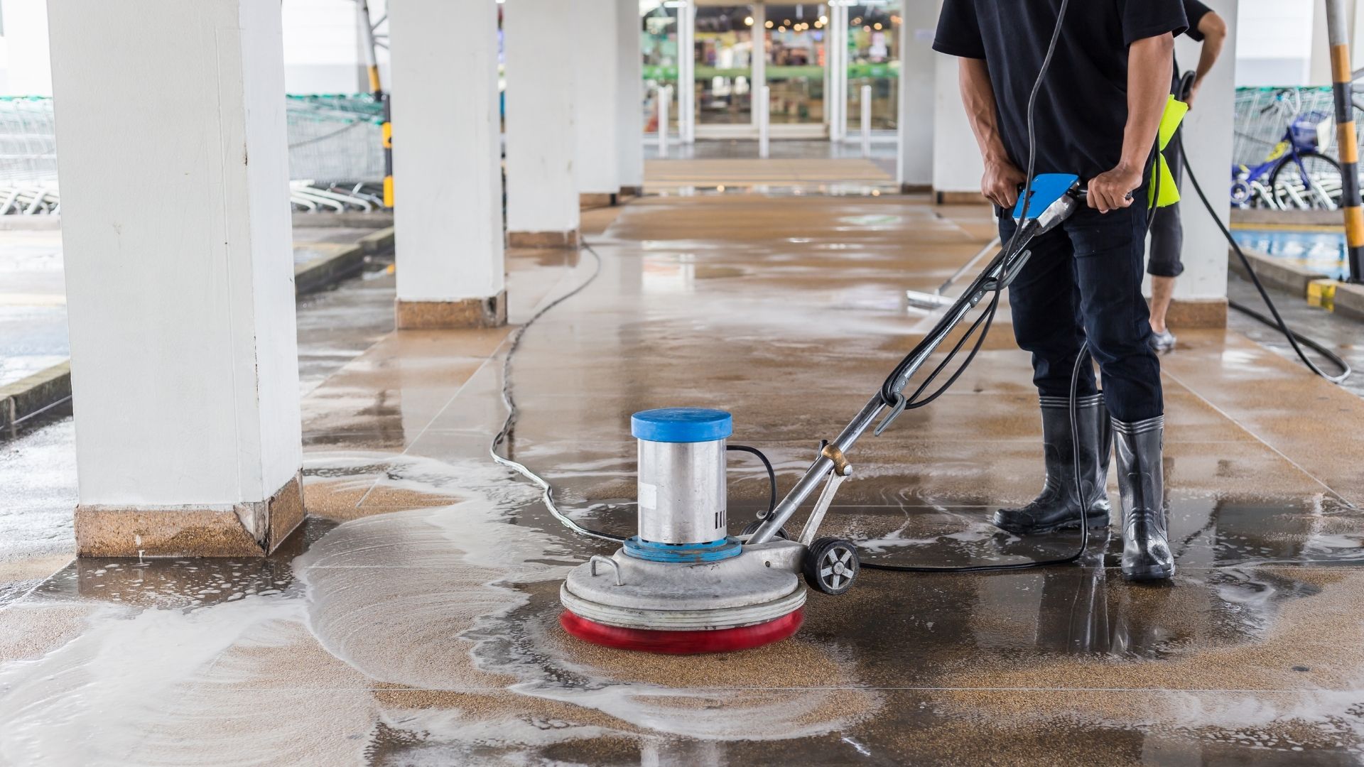 professional cleaning commercial concrete with pressure washer