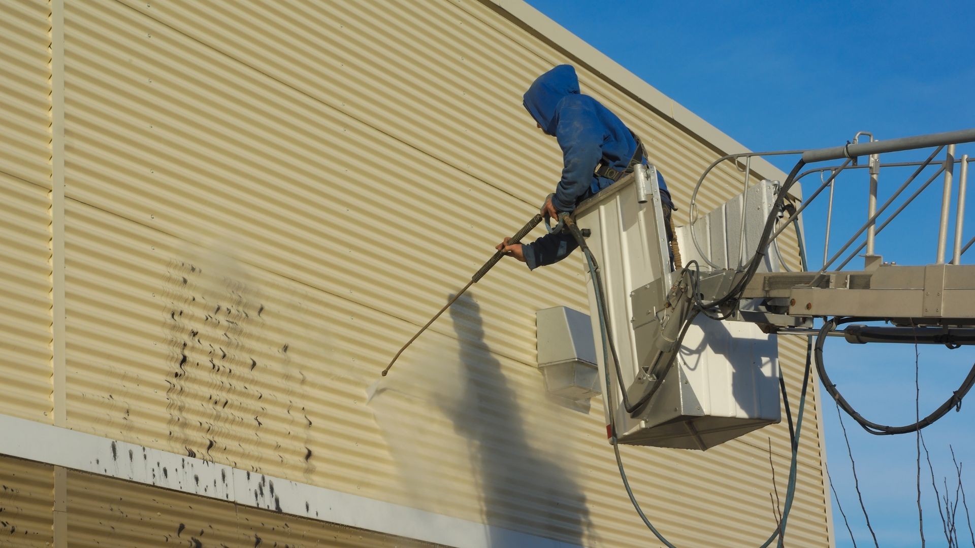 professional pressure washing siding of commercial property