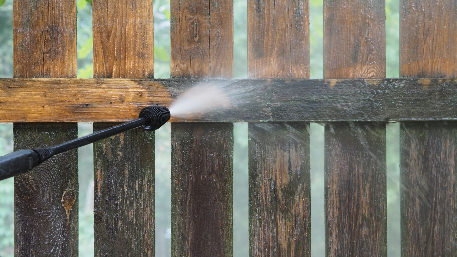 professional pressure washing fence before and after cleaning